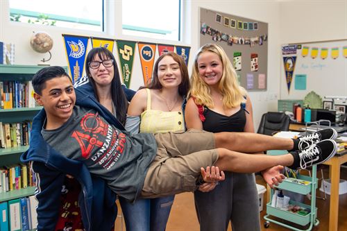 Students holding up another student.